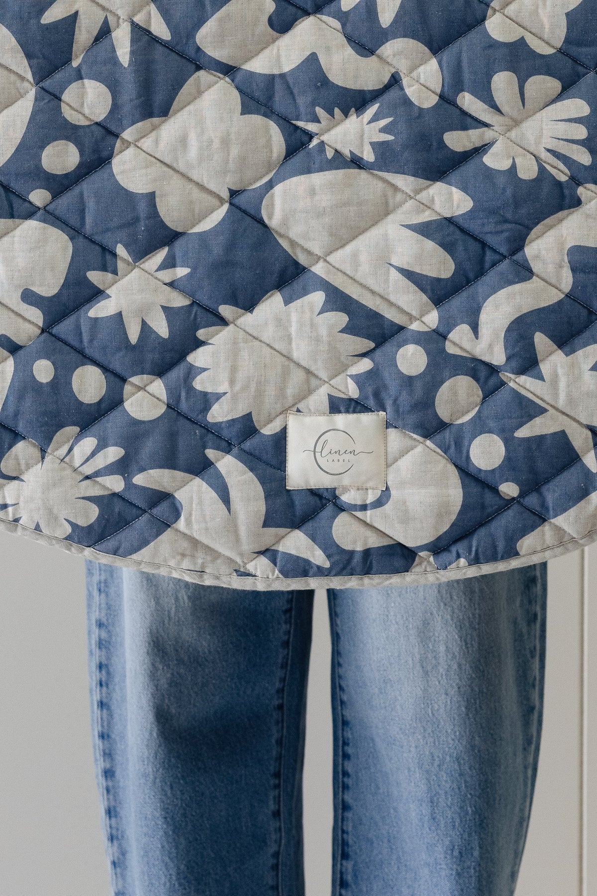 Linen Label round play mat in Denim Blue Print shown in a living room