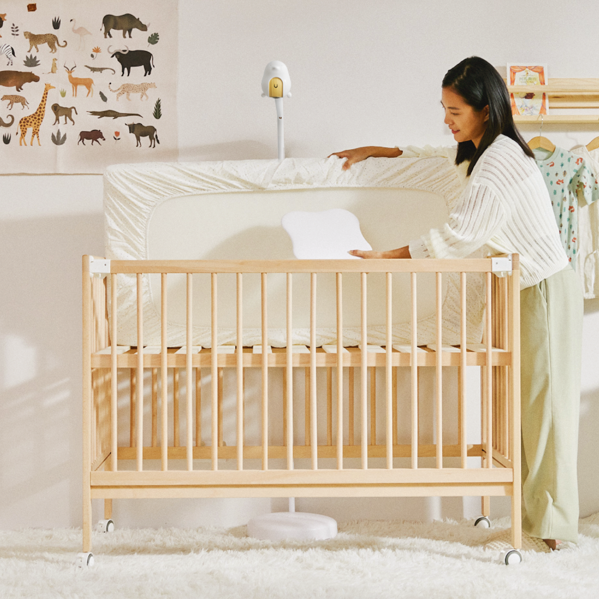 CuboAi Sleep Sensor Pad shown under a cot mattress on the bed slats
