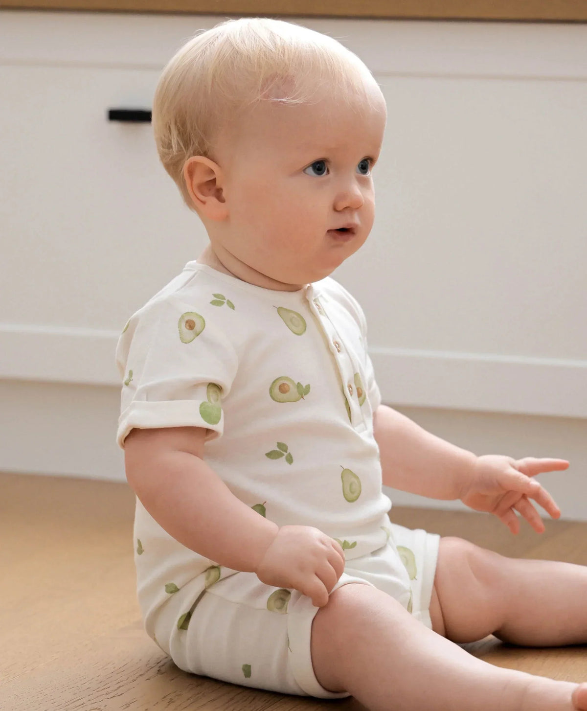 Lummi in Colour romper showing the stud closure