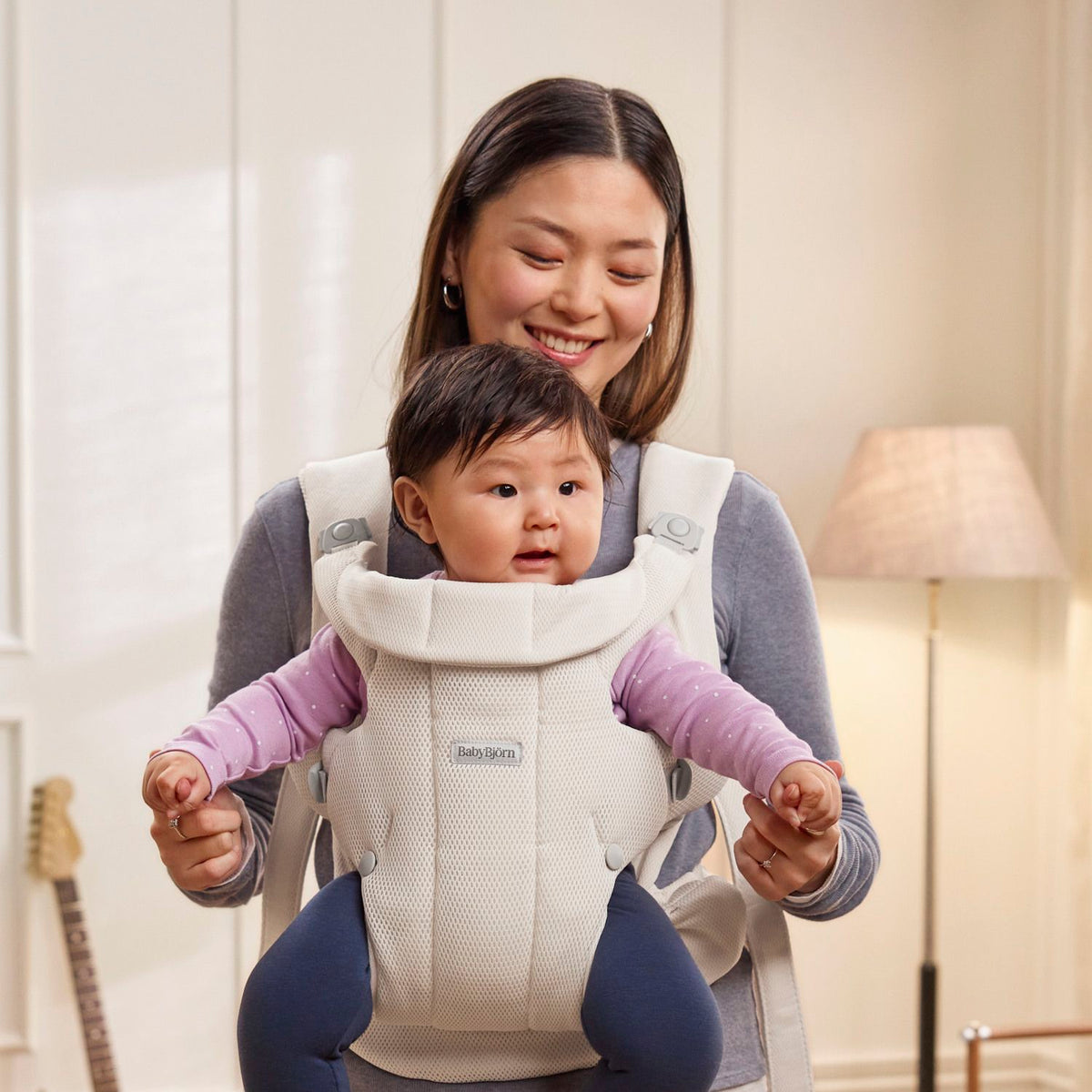 Baby facing out in the BabyBjorn Baby Carrier Hold Cream
