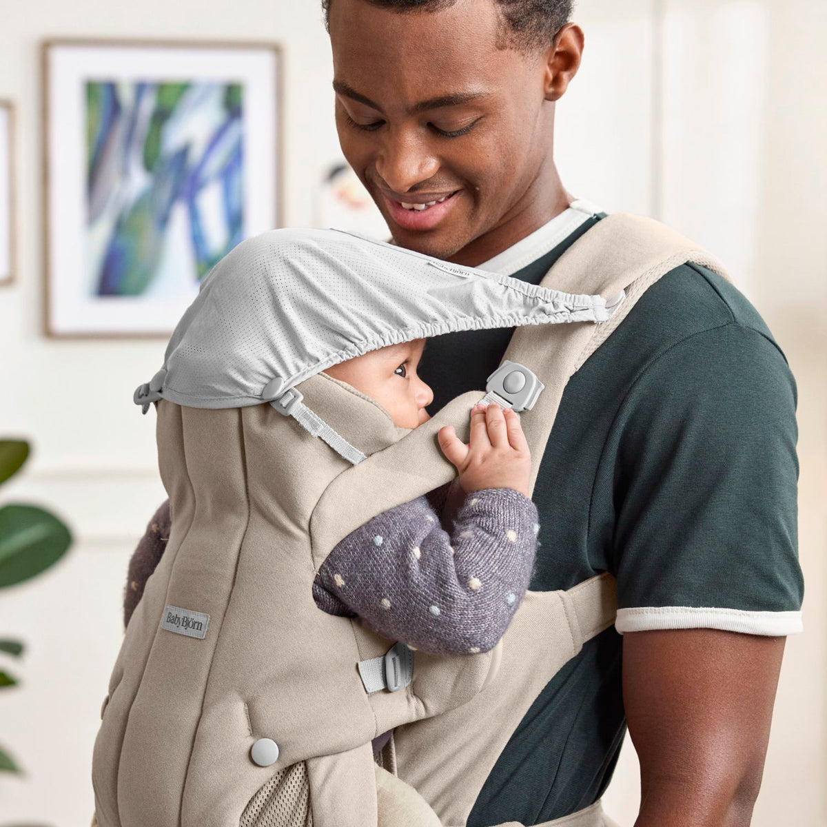 BabyBjorn Baby Carrier Hold Sand Grey with the integrated shade in use