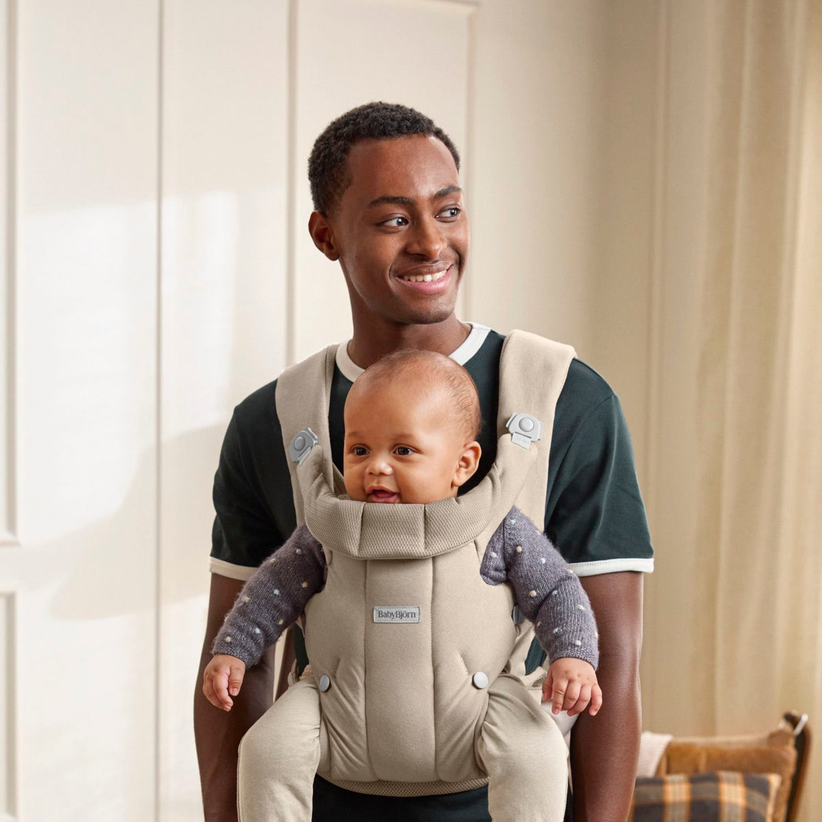 Baby facing out in the BabyBjorn Baby Carrier Hold Sand Grey