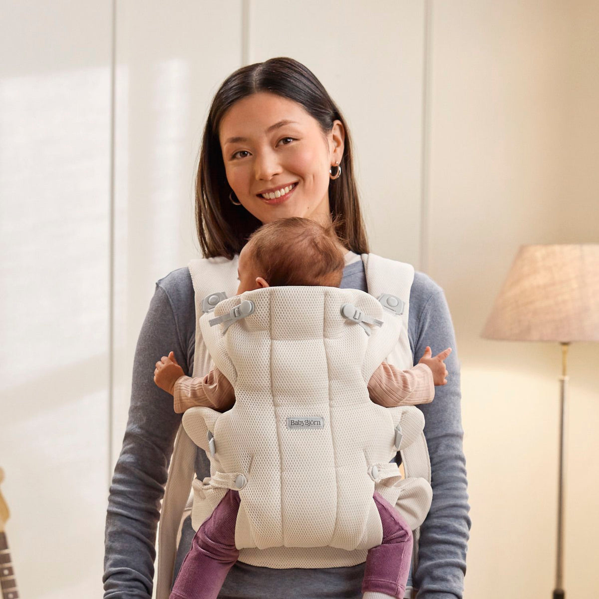 Baby facing in, snug in the BabyBjorn Baby Carrier Hold Cream