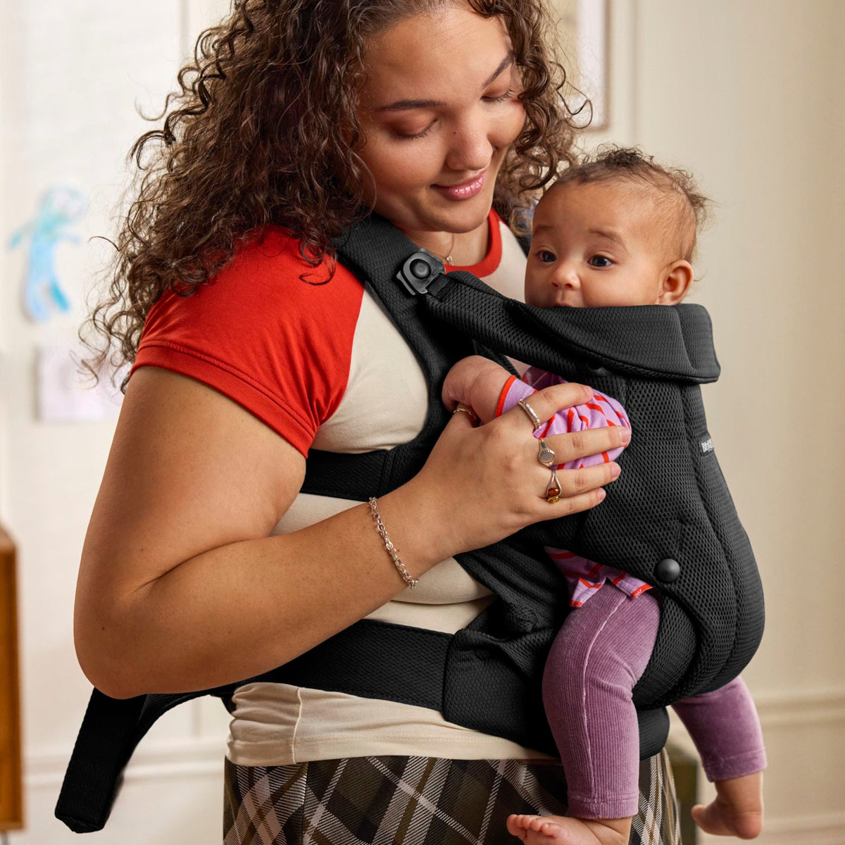 Baby facing in, snug in the BabyBjorn Baby Carrier Hold Black