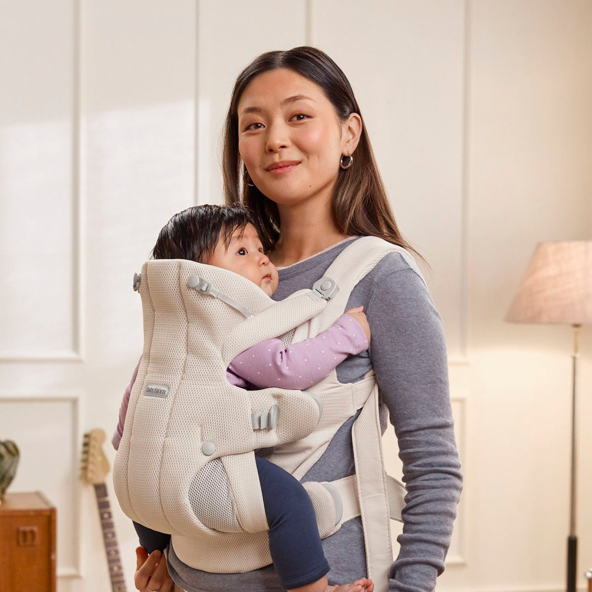 Parent wearing the BabyBjorn Baby Carrier Hold in Cream Airy Mesh