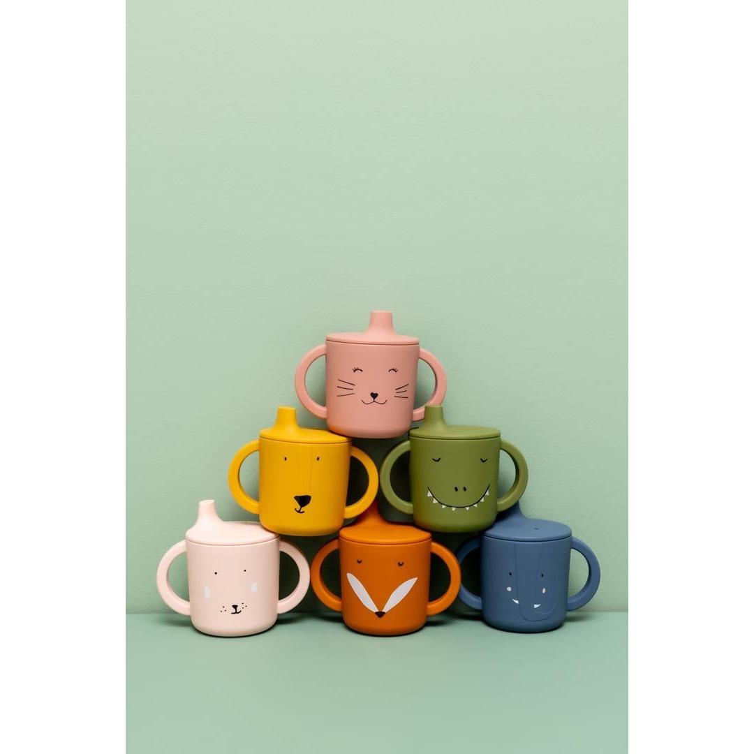 Trixie Mr. Lion sippy cup showing soft silicone spout and ergonomic handles